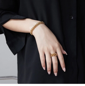 Detail of 18K gold plated multi-layer beaded bracelet and ring on a hand
