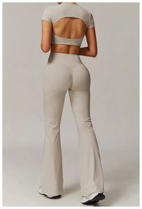 Detailed back view of high waist flared yoga pants with hollowed-out short sleeve top