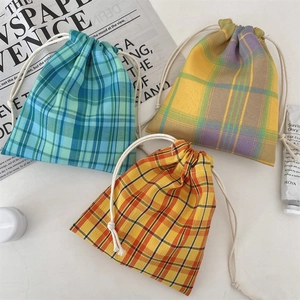 Three-piece checkered drawstring pouches in blue-green, purple, and orange cotton fabrics