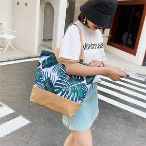 Linen tote bag with green leaf pattern and khaki patchwork shown on a model