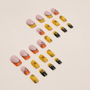Flat lay of Halloween press-on nails with spider, web, and orange flame designs