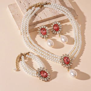 Baroque multilayer pearl jewelry set with red oval crystals and floral gold accents