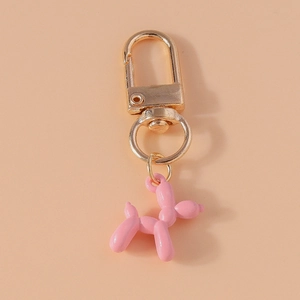 Detailed close-up of pink balloon dog keychain with golden lobster clasp for bags