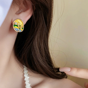 Detail view of vintage enamel oval earring with pearl on model for elegant styling