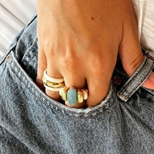 Retro style layered gold rings with light blue oval stone and white enamel finish