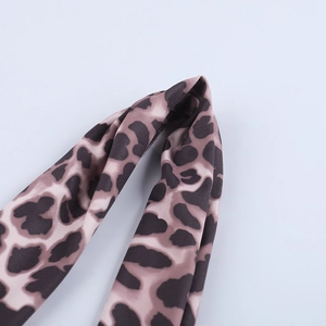 Detailed macro view of leopard print pattern and fine stitching on high-elastic fabric
