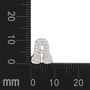 Macro detail of zircon paved letter A charm showing 12mm size on measuring scale