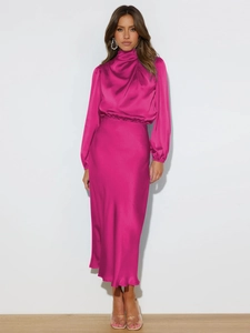 Detail of rose red satin halter neck dress with silky texture and elegant pleats