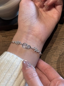 Close-up of a zircon bow knot bracelet with moonstone on a woman's wrist