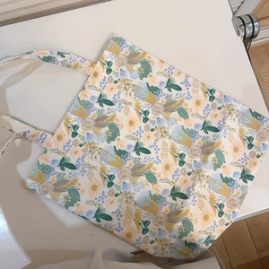 Detailed view of large capacity floral canvas tote bag with vibrant yellow and blue prints