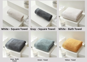 Close-up of premium cotton towels with geometric wave texture and neat stitched edges