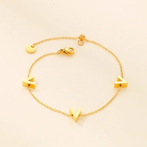 Detail of 18K gold-plated titanium bracelet featuring three 3D V-shaped pendants and clasp