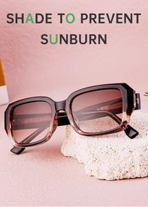 Detail of square gradient brown sunglasses resting on white volcanic stone with pink background