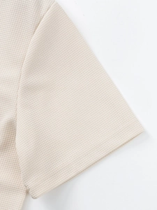 Detailed close-up showing the waffle weave texture and stitching on men's apricot shirt