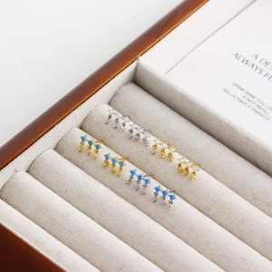 Luxurious S925 silver opal stud earrings set in gold and silver finishes on linen
