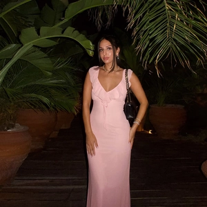 Elegant pink sleeveless V-neck maxi dress with ruffles and waist tie for evening party