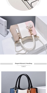 Close-up of elegant color-block handbag with metal ring handle and pearl charm detail