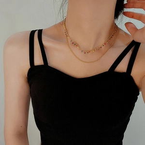 Double-layer gold titanium steel necklace with colorful enamel charms on model
