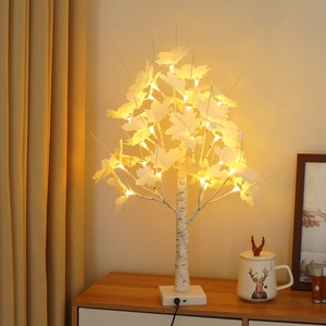Detail showing the white birch maple leaf LED tree lamp with warm white glowing lights