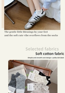 Detailed view of soft cotton socks with 'Nice' fabric label and polka dot patterns