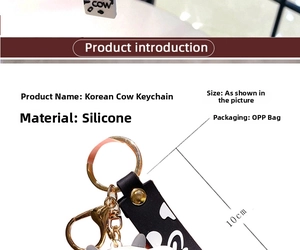 Detail of cute cow keychain showing 10cm silicone pendant and striped wrist strap