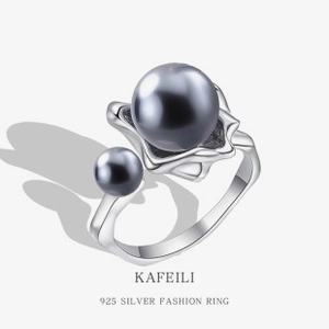 Macro shot of 925 silver ring featuring two elegant grey and black pearls in detail