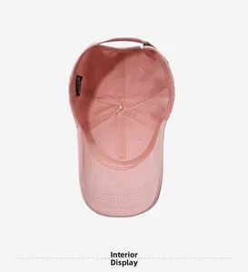 Interior view of pink cotton baseball cap showing reinforced seams and adjustable metal buckle