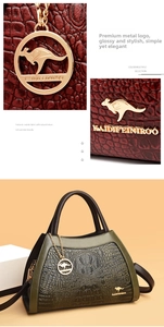 Detail view of textured cowhide tote bag with dark green crocodile pattern and gold hardware