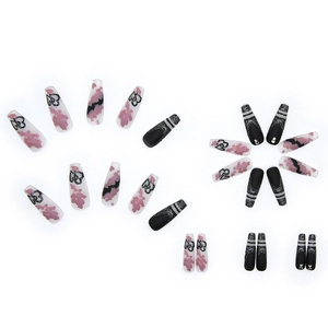 Long ballet press-on nails featuring matte black finish, silver glitter and heart patterns