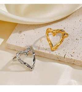 Detailed view of hollow heart rings with lava texture in gold and silver finishes