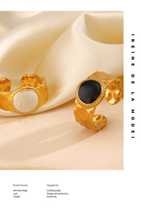 Macro detail of adjustable 18K gold plated rings with black and white drip oil texture