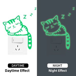 Luminous sleeping cat wall sticker showing daytime look vs green glow in the dark effect