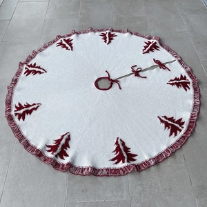 Detail of knitted 48 inch Christmas tree skirt with red tree patterns and tassel edges