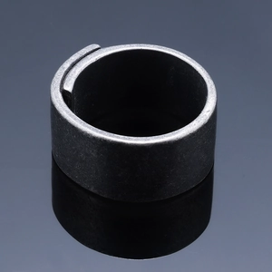 Macro view of a wide vintage grey matte metal ring with a wrap-around overlapping design