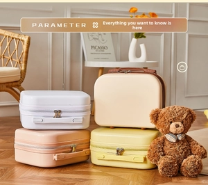 Detailed stack of 14-inch mini hardshell vanity cases in white, cream, pink, and yellow