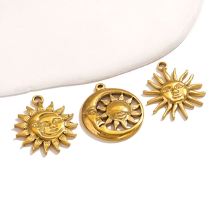 Detailed view of three vintage gold sun and moon pendants for DIY jewelry making