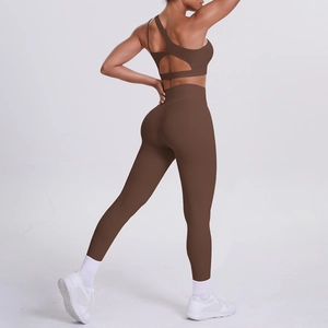 Detail of side-back view of dark brown one-shoulder sports bra and high-waisted leggings set