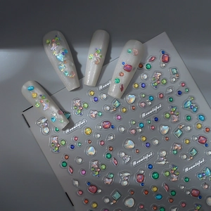 Colorful diamond nail stickers with 3D heart and bow designs on pearly white nails