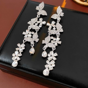 Close-up of sparkling butterfly tassel earrings with rhinestones and drop pendants