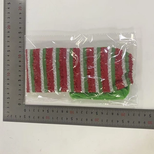 Close-up of striped Christmas elf leg covers with sparkly red and green metallic yarn