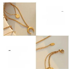 Detailed macro view of 18K gold plated celestial necklace with moon and star pendants