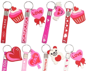 Various silicone Valentine's Day keychains with heart and bear shapes on white background