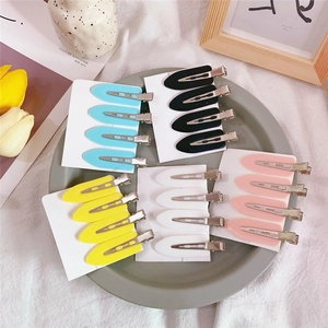 Detailed view of macaron-colored teardrop hair clips on cards in a stylish setting