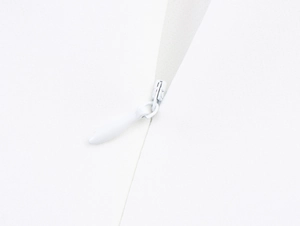 Close-up of white invisible zipper and fabric texture on back of elegant dress