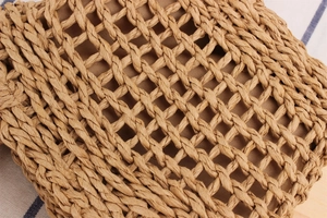 Close-up of the woven paper rope texture on a lightweight beach crossbody bag