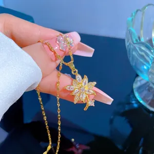 Detailed view of an 18K gold-plated floral pendant with shimmering zircon pavé stones