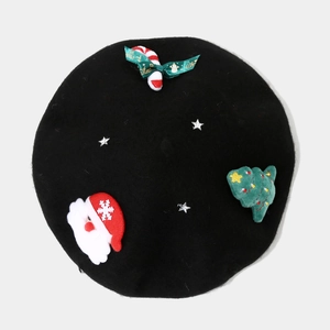 Close-up of black wool beret featuring Santa Claus, Christmas tree and candy cane details
