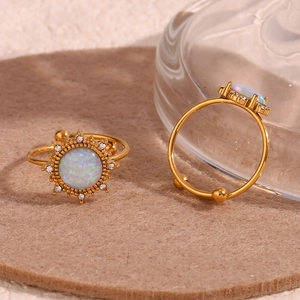 Detail of 18K gold plated stainless steel rings featuring opal and adjustable band