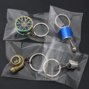 Set of four metal car part keychains including turbo and shifter in clear OPP bags