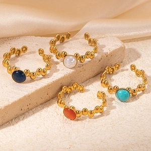 Vintage 18K gold plated titanium steel rings with colorful gemstones on silk and stone